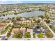 An aerial view displaying a neighborhood near a lake, surrounded by lush green trees at 6731 Ranger Dr, Tampa, FL 33615