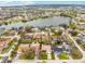 An aerial view shows single-Gathering homes surrounded by mature trees near a tranquil lake at 6731 Ranger Dr, Tampa, FL 33615