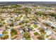 An aerial view shows a neighborhood featuring a serene lake at 6731 Ranger Dr, Tampa, FL 33615