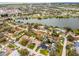 A picturesque aerial shot of a residential neighborhood featuring lush greenery and a beautiful lake at 6731 Ranger Dr, Tampa, FL 33615