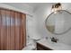 Clean bathroom with a shower-tub combo, toilet, and decorative mirror and lighting at 6731 Ranger Dr, Tampa, FL 33615