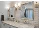 Bathroom with double vanity, modern faucets, decorative tile wall, and framed mirrors at 6731 Ranger Dr, Tampa, FL 33615