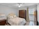 Bedroom featuring a comfortable bed, side tables, ceiling fan, and ample natural light at 6731 Ranger Dr, Tampa, FL 33615