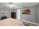 Bedroom with a tufted headboard, ceiling fan, and a TV mounted on the wall at 6731 Ranger Dr, Tampa, FL 33615