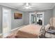 Bedroom featuring a tufted headboard, a TV mounted on the wall, and sliding glass doors at 6731 Ranger Dr, Tampa, FL 33615