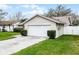 Front exterior with a well-maintained lawn and two-car garage at 6731 Ranger Dr, Tampa, FL 33615