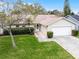 Charming single-story home featuring a manicured front lawn, well-maintained landscaping, and a two-car garage at 6731 Ranger Dr, Tampa, FL 33615