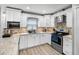 Modern kitchen featuring white cabinetry, stainless steel appliances, and granite countertops at 6731 Ranger Dr, Tampa, FL 33615