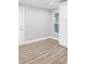 Bright modern kitchen features white cabinets, white door, and wood-look floors at 6731 Ranger Dr, Tampa, FL 33615