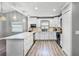 Updated kitchen with white cabinets, granite countertops, stainless appliances, and a functional island at 6731 Ranger Dr, Tampa, FL 33615