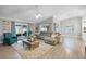 Bright living room with vaulted ceilings, wood floors, and sliding glass doors to the backyard patio at 6731 Ranger Dr, Tampa, FL 33615
