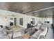 Covered patio with comfortable seating, ceiling fan, and sliding glass doors for indoor/outdoor living at 6731 Ranger Dr, Tampa, FL 33615