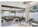 Relaxing screened patio featuring comfortable wicker seating and a ceiling fan at 6731 Ranger Dr, Tampa, FL 33615