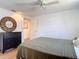 Bright bedroom featuring a ceiling fan, wood-look floors, and a dresser at 7525 Sundial Ter, Sarasota, FL 34231