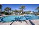 Resort style pool with deck chairs and umbrellas surrounded by lush landscaping at 11120 Wicker Park Pl, Palmetto, FL 34221