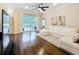 Bright living room with hardwood flooring, ceiling fan and sliding glass doors at 11794 Forest Park Cir, Bradenton, FL 34211