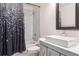 Bathroom featuring a vessel sink, shower/tub combo with marble tile surround and decorative shower curtain at 15719 Starling Water Dr, Lithia, FL 33547