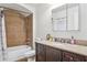 Bathroom featuring a tub/shower combo with tile surround, framed mirror, and granite-topped vanity at 15719 Starling Water Dr, Lithia, FL 33547