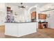 Open concept kitchen featuring granite countertops, a breakfast bar, and cherry wood cabinetry at 15719 Starling Water Dr, Lithia, FL 33547