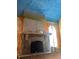 Room featuring a large, ornate fireplace, with a dark stone hearth and blue ceiling at 1827 2Nd E Ave, Bradenton, FL 34208