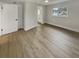 A well-lit bedroom boasts new flooring and a view to the bathroom at 2642 49Th N St, St Petersburg, FL 33710