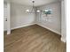 Bright dining room with wood floors, modern light fixture, and a large window view at 2642 49Th N St, St Petersburg, FL 33710