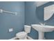 Charming half bathroom featuring a pedestal sink and blue walls at 4324 Spinnaker Cove Ln, Tampa, FL 33615