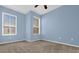 Well-lit bedroom featuring a ceiling fan, carpet floors, and large windows at 4324 Spinnaker Cove Ln, Tampa, FL 33615