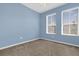 Blue bedroom with carpet and two windows that allow for ample natural light at 4324 Spinnaker Cove Ln, Tampa, FL 33615