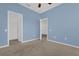 Light blue bedroom showcasing carpeting, doorways, and neutral decor at 4324 Spinnaker Cove Ln, Tampa, FL 33615