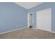 A bedroom with plush carpeting, a ceiling fan and blue painted walls at 4324 Spinnaker Cove Ln, Tampa, FL 33615