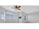 Large bedroom with natural light, a ceiling fan and a wall-mounted television at 4324 Spinnaker Cove Ln, Tampa, FL 33615