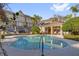 Exterior view of a community pool with lounge chairs and a shaded seating area at 4324 Spinnaker Cove Ln, Tampa, FL 33615