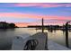 Waterfront dock with boat lift and stunning sunset views over the harbor at 4324 Spinnaker Cove Ln, Tampa, FL 33615