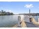 Dockside view featuring boat refueling station, with waterfront homes and a bright sunny sky at 4324 Spinnaker Cove Ln, Tampa, FL 33615