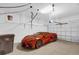 Garage showcasing an orange sports car, storage shelves, and a hoist at 4324 Spinnaker Cove Ln, Tampa, FL 33615