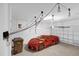 Spacious garage showcasing an orange sports car, storage shelves, and hoist systems at 4324 Spinnaker Cove Ln, Tampa, FL 33615