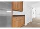 Kitchen cabinetry in light wood, with a stainless steel fridge and granite countertops at 4324 Spinnaker Cove Ln, Tampa, FL 33615