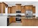 Bright kitchen with wood cabinets, stainless steel appliances, and granite countertops at 4324 Spinnaker Cove Ln, Tampa, FL 33615