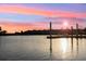 Waterfront view with a dock, and serene lake under a beautiful sky at 4324 Spinnaker Cove Ln, Tampa, FL 33615