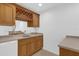 Close up of the wet bar shows the sink, cabinets and storage, mini fridge, and wine rack at 4324 Spinnaker Cove Ln, Tampa, FL 33615