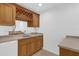 Cozy wet bar features wooden cabinets, granite countertop, sink and space for a mini fridge at 4324 Spinnaker Cove Ln, Tampa, FL 33615