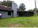Backyard featuring a patio and view of well-maintained trees at 4375 Neff Lake Road, Brooksville, FL 34601