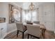 Relaxing dining room featuring a rustic table, an elegant chandelier, and neutral decor at 6007 N Orange Blossom Ave, Tampa, FL 33604