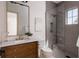 Bathroom with dark wood cabinets, marble countertop and updated shower with modern fixtures at 1056 Snell Isle Ne Blvd, St Petersburg, FL 33704