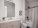Bright bathroom featuring marble countertops and updated shower and tub with modern fixtures at 1056 Snell Isle Ne Blvd, St Petersburg, FL 33704