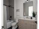 Bathroom with marble countertops and updated shower and tub with modern fixtures at 1056 Snell Isle Ne Blvd, St Petersburg, FL 33704