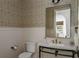 Powder bath with pedestal sink, unique patterned wallpaper, and white wainscoting at 1056 Snell Isle Ne Blvd, St Petersburg, FL 33704