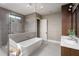 Modern bathroom featuring a soaking tub, glass-enclosed shower, stylish fixtures, and elegant wallpaper at 1056 Snell Isle Ne Blvd, St Petersburg, FL 33704