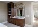 Elegant bathroom with double vanity, wooden cabinetry, decorative mirrors, and designer wallpaper at 1056 Snell Isle Ne Blvd, St Petersburg, FL 33704